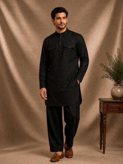 Man wearing jet black linen pathani kurta with dual chest flap pockets and matching salwar mandarin collar mens premium ethnic co-ord set Ethnoir